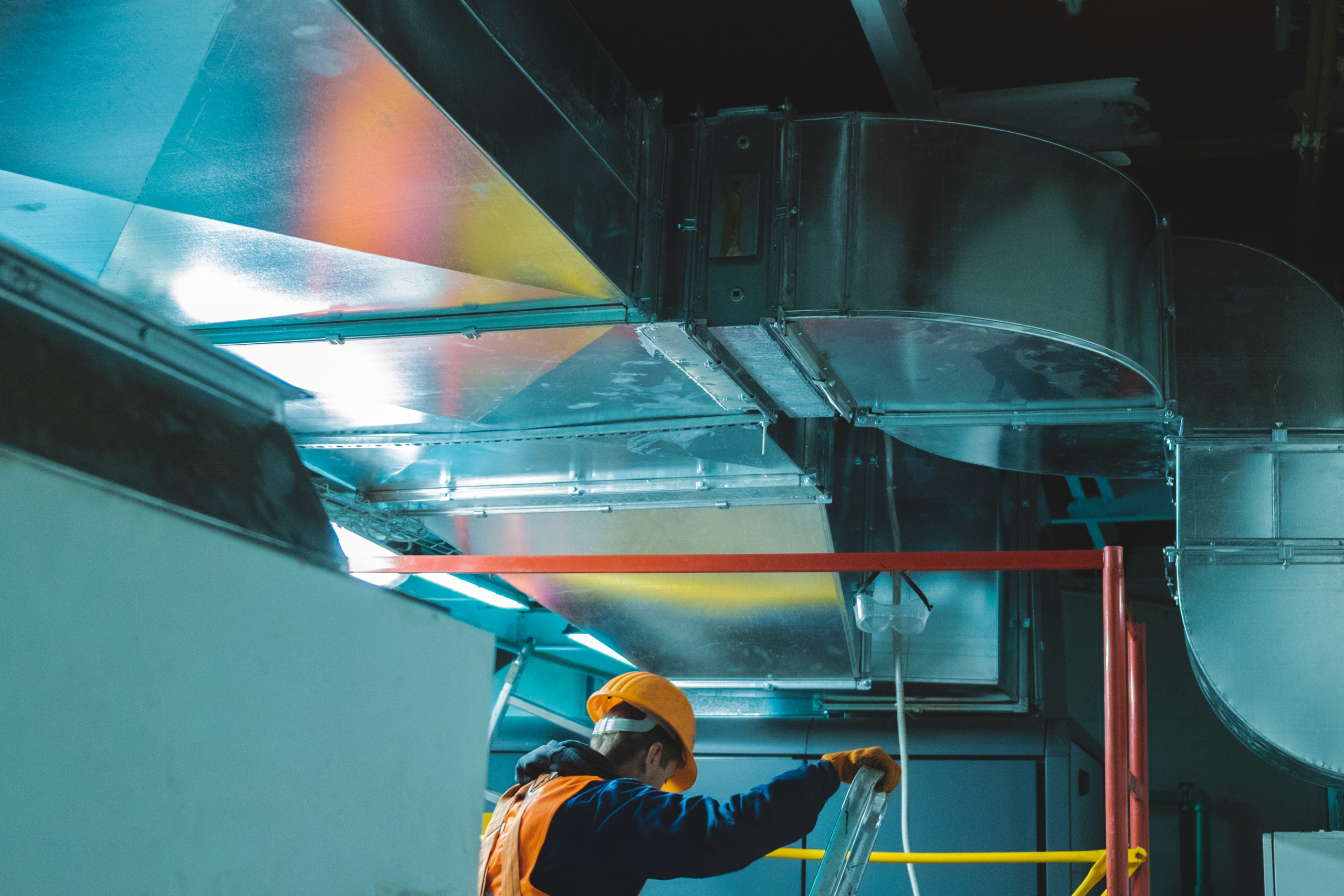 Young,Man,In,Orange,Work,Vest,,Safety,Belt,And,Hard